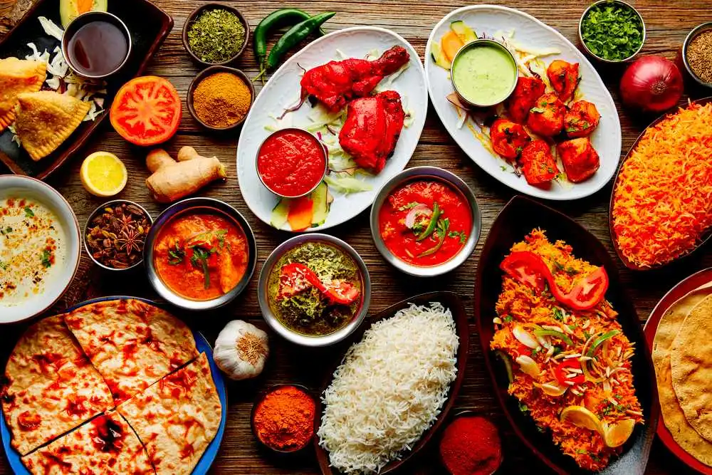 Most Delicious Food: A vibrant spread of Indian cuisine featuring colorful curries, rice dishes, and naan bread, showcasing the rich flavors and spices of Indian cooking.